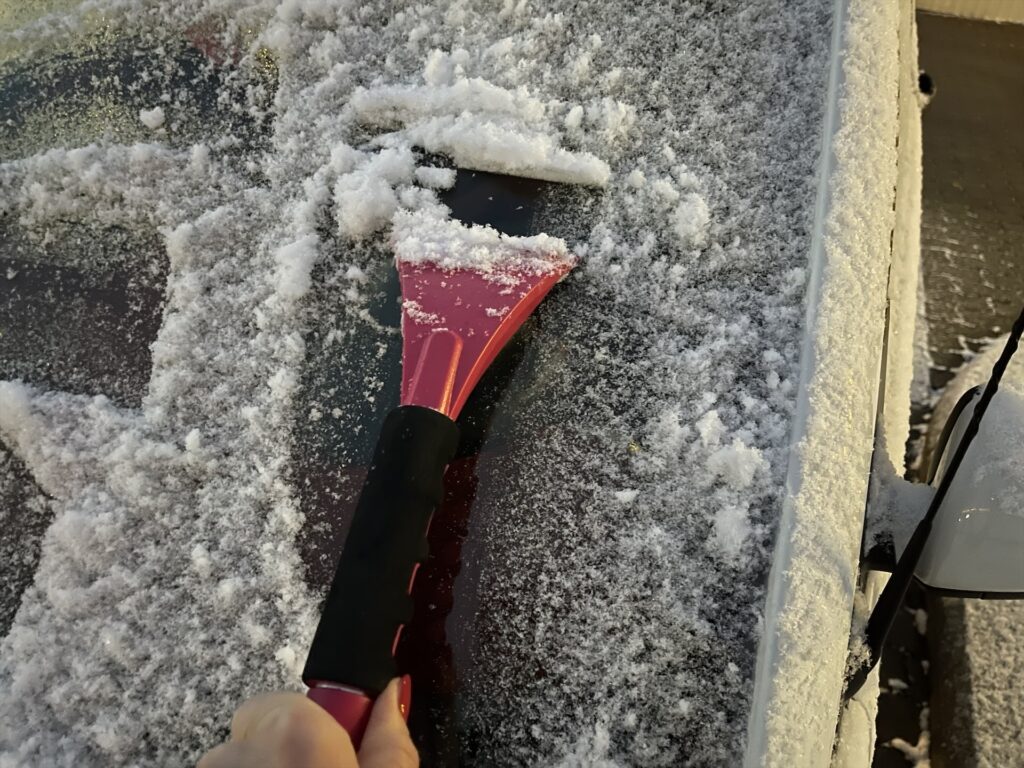 Eiskratzen am Autofenster
